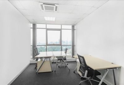 Bright private office suite with two desks and large windows overlooking the city.
