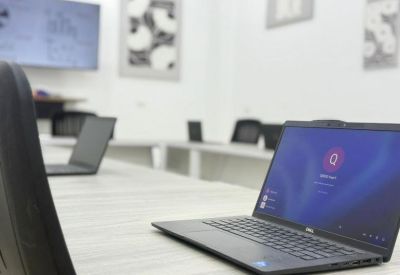 Laptop display on a white desk in a bright, modern office setting.