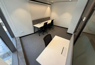 Private office space with two white desks and ergonomic chairs.