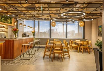 Spacious communal dining area with wood paneling and varied seating options.
