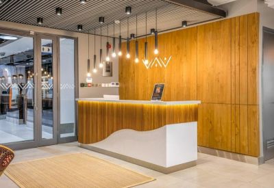 Professional reception desk with wood vertical slats and a wavy white base.