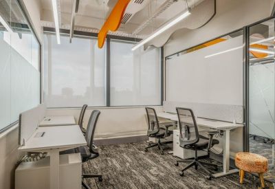 Modern four-person private office with ergonomic chairs and large windows.