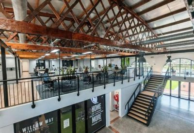 Reception area featuring a lush green moss wall and sleek wooden front desk.