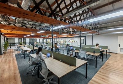 Modern conference room featuring a large wooden table and geometric wall art.