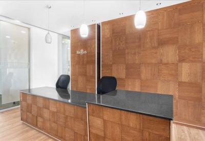 Professional reception area featuring a wood-paneled desk and matching feature wall.