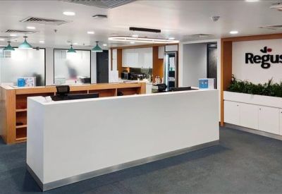 Reception area with a white front desk and branded signage.