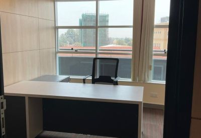 Private office featuring a white desk and large window with city views.