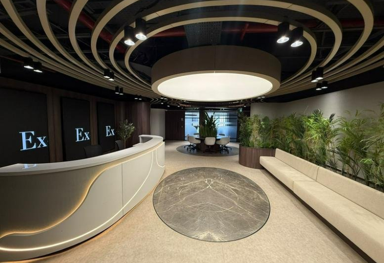 Modern lobby at road, New Cairo featuring a curved reception desk and designer ceiling lighting.