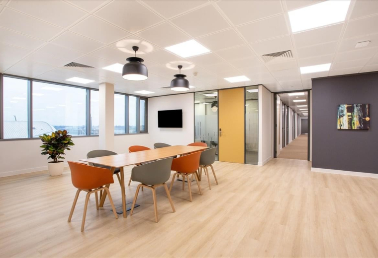 Spacious communal dining area at Zia Business Complex, New Administrative Capital, Cairo with warm wood floors.