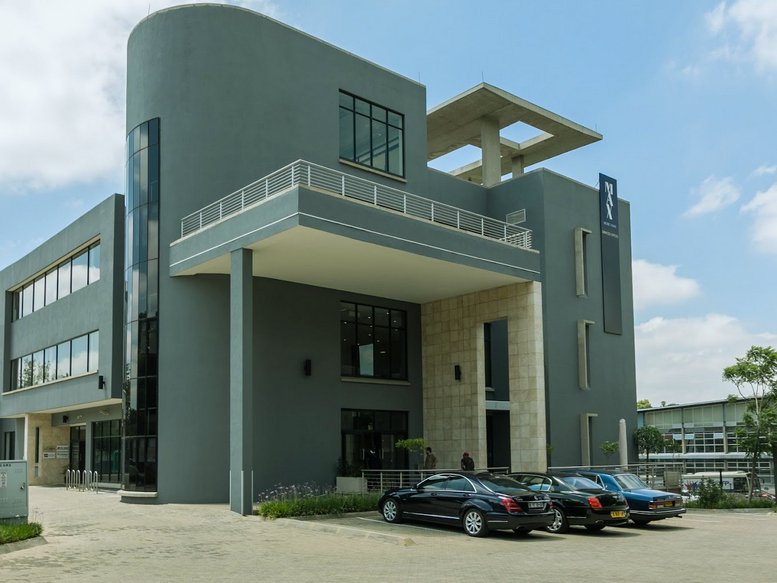 Exterior view of the contemporary gray building with a rounded facade at 145, Second Street.