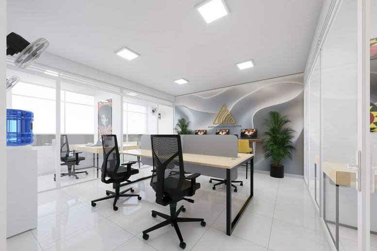 Modern open-plan office at TRV Building featuring minimalist desks, ergonomic chairs, and indoor plants.