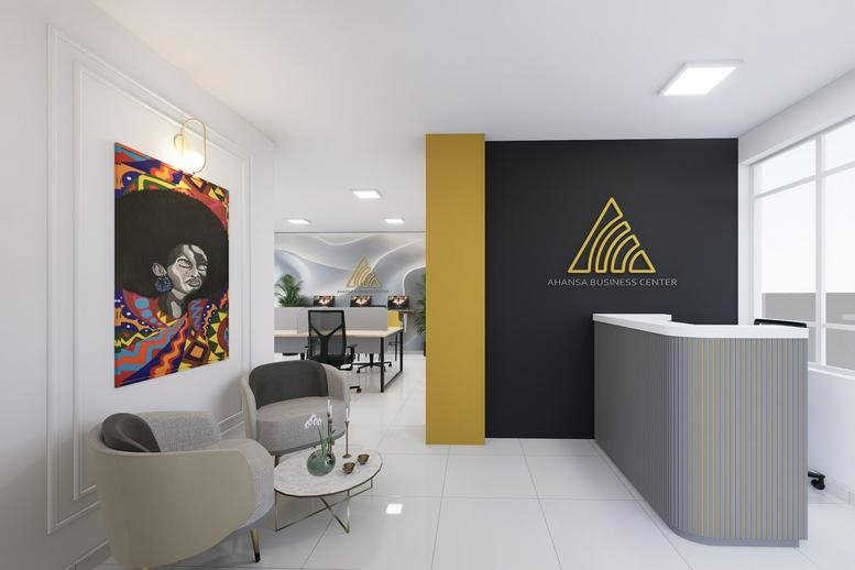 Reception area at the TRV Building featuring a grey desk, lounge chairs, and colorful artwork.