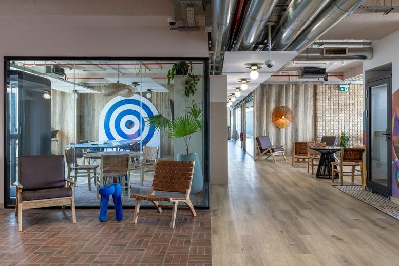 Spacious communal area at Mercure Nairobi Upper Hill with diverse seating and a vibrant mural.