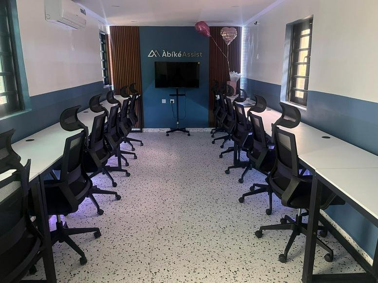 Long open-plan workspace at 34, Sabiu Ajose Street, Surulere, Lagos with blue accent walls and ergonomic chairs.