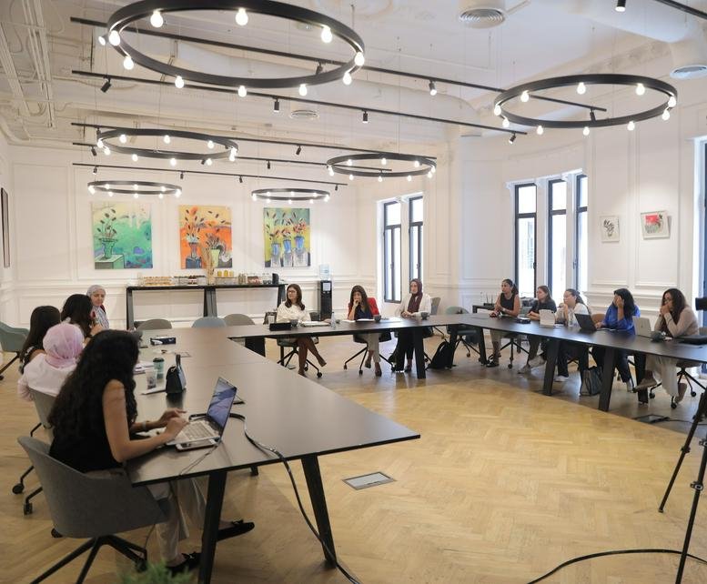 Spacious meeting room at 5 El-Fadl Street, Bab Al Louq, Abdeen with circular chandelier lighting and group discussions.