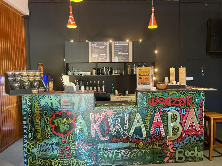 Vibrant reception desk at John Evans Mills Avenue, Kingsway with colorful graffiti and hanging pendant lights.