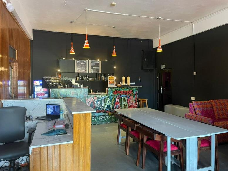 Wide view of The Haven Workspace showing a reception desk and large communal work table.