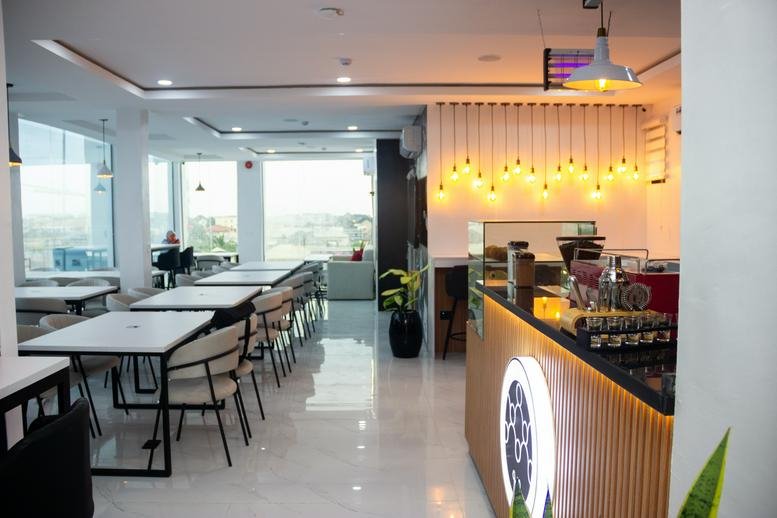 Spacious lounge and café area at Ocean Mall with modern tables, pendant lighting, and views through large windows.