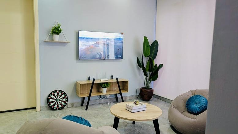 Lounge area at Palace Road, Victoria Island, Lagos, Nigeria featuring bean bags and a wall-mounted TV.