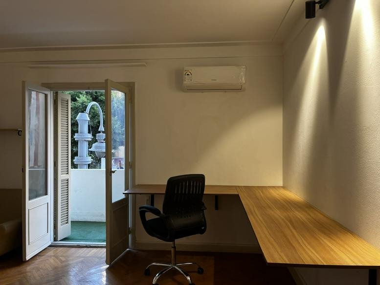 Spacious workspace at The Circle, 15 Syria Street with wooden L-shaped desks and balcony access.