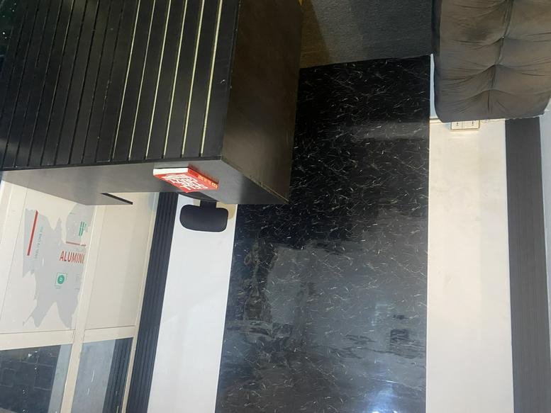 Modern reception desk at Cre8VX Hub featuring a sleek dark wood finish and branded map graphic.
