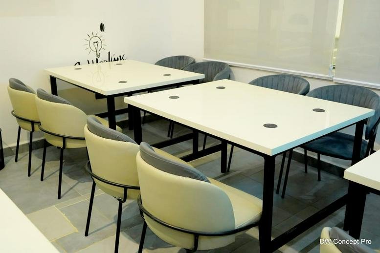 Meeting room at State Library, Stadium Poolside, Calabar, Nigeria with white tables and modern beige and grey chairs.