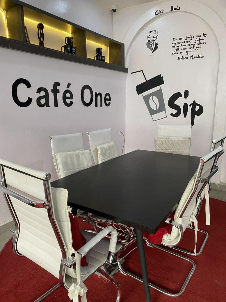 Meeting room at The Palms Mall, Ring Road, Ibadan, with white chairs and Mandela quote on the wall.