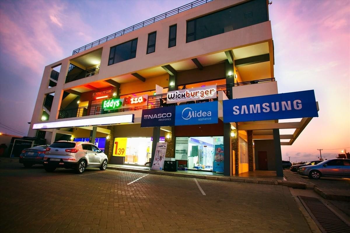 Exterior view of the multi-story commercial building Soromall, Spintex Road, Accra at dusk.