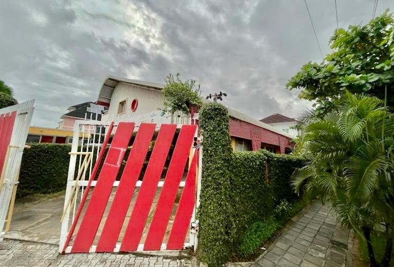 Exterior entrance of Oba Akinloye Drive,Opposite Orchid Hotel featuring a red and white striped gate.