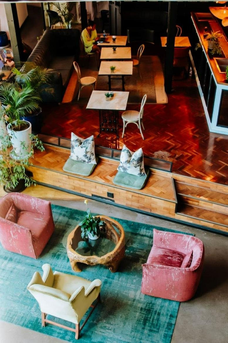Aerial view of a colorful communal lounge at The Old Foundry, 1 Sand Hill Road, Green Point, Cape Town, South Africa.