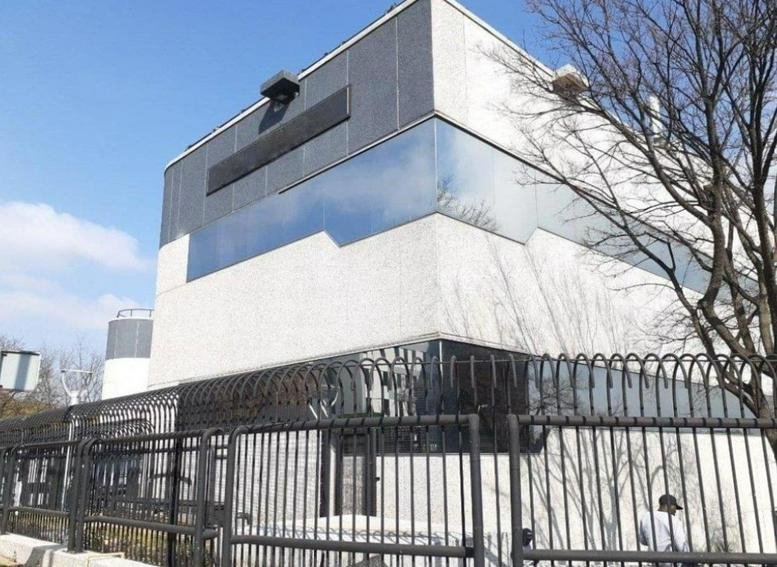 Exterior view of the modern stone and glass facade building at 1 Sturdee Avenue, Rosebank.