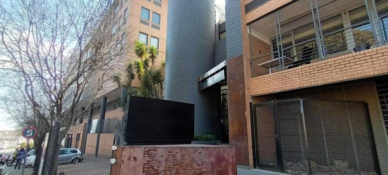 Modern multi-story brick facade of the building at 158 Jan Smuts Avenue, Rosebank.