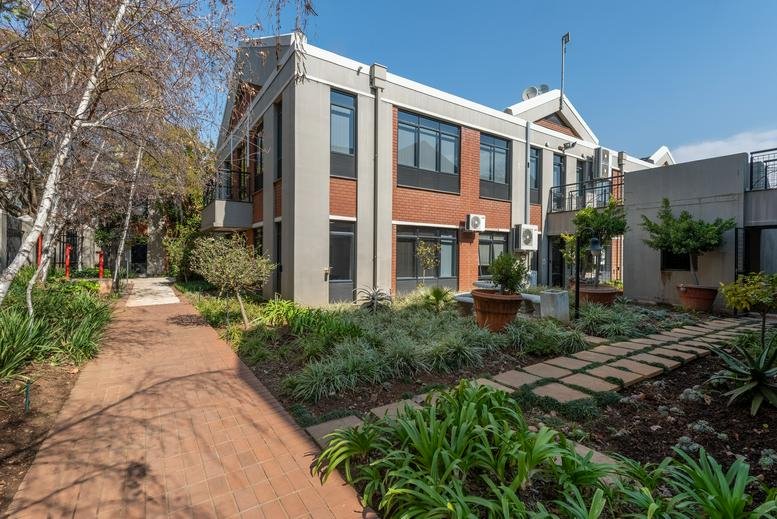 Exterior view of the multi-story brick and grey office building at 23 Sturdee Avenue.