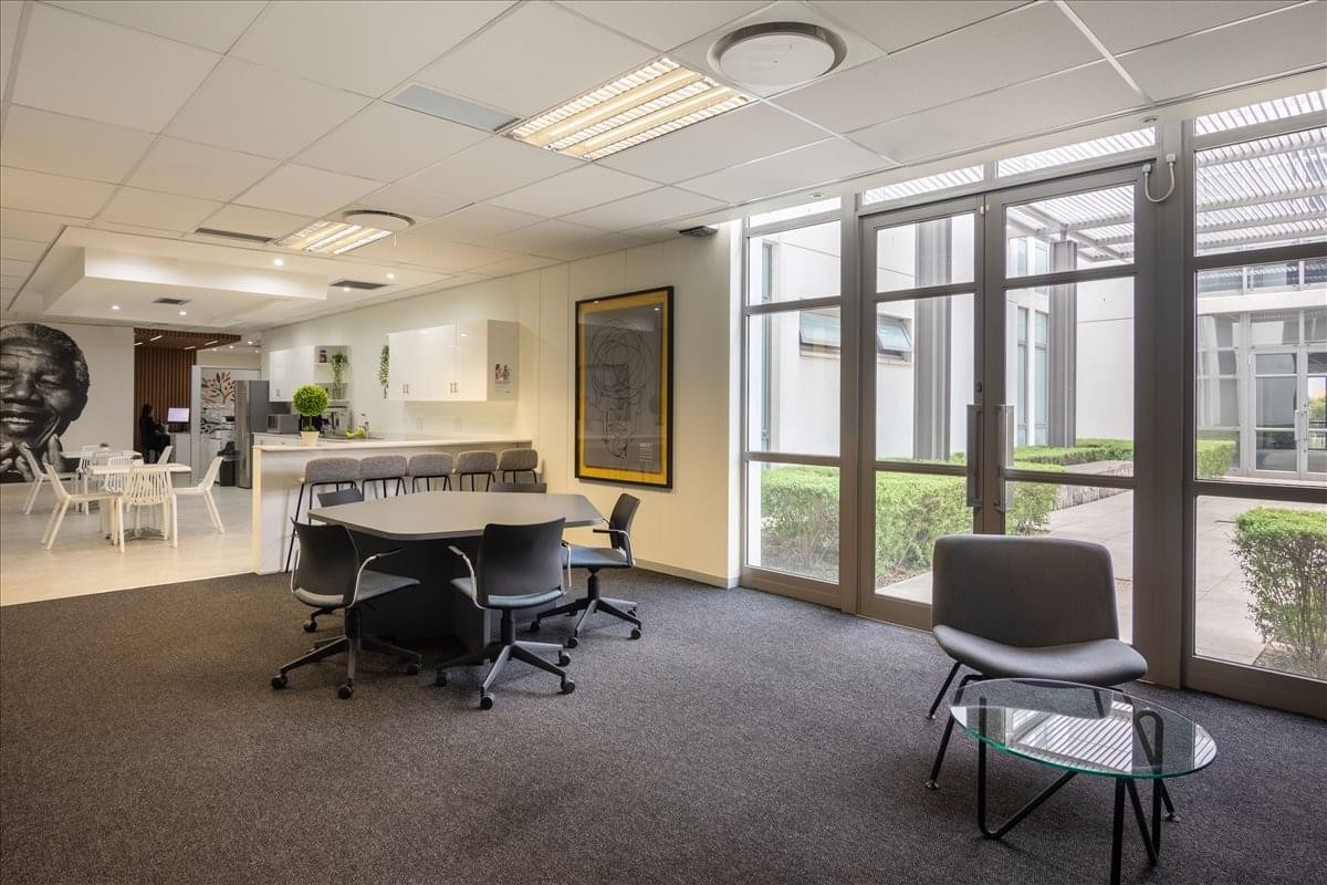 Wide view of the reception at Mac Building with floor-to-ceiling windows and lounge seating.