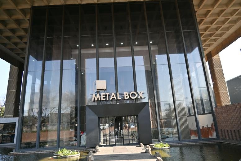 Street-level view of the glass entrance facade of the Metal Box building.