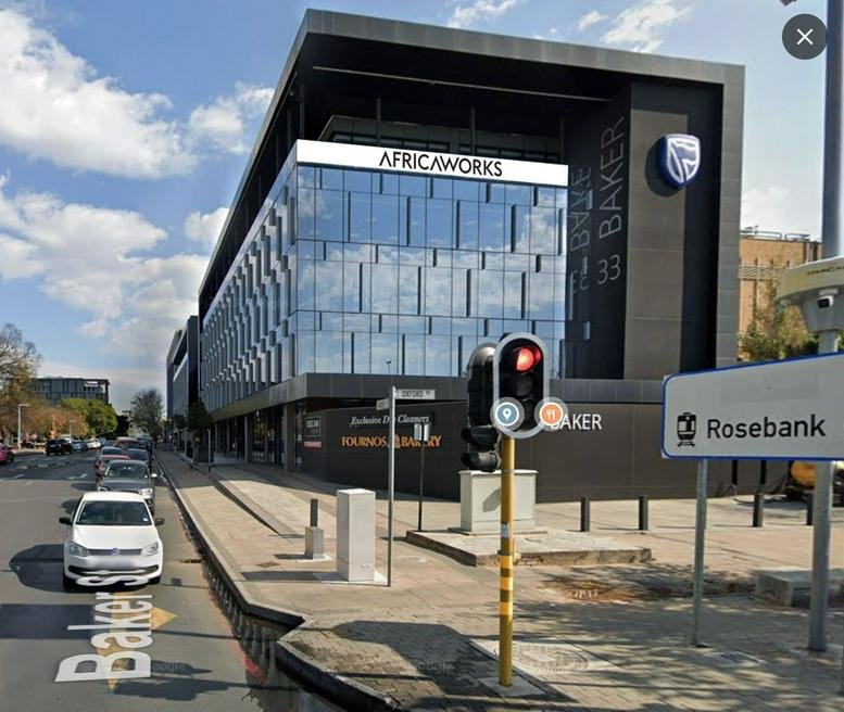 Modern glass-fronted exterior of 33 Baker Street in Rosebank.