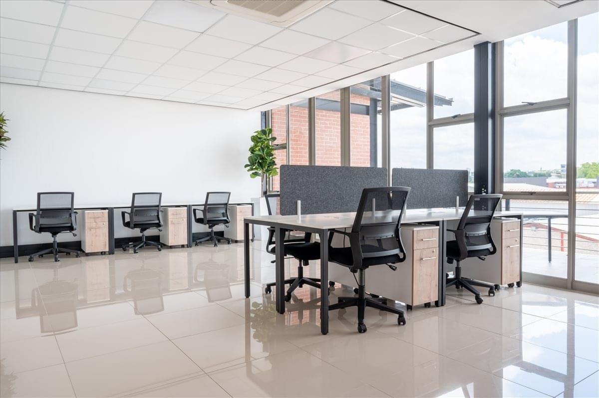 Spacious open-plan workspace at Northlands Corner with ergonomic chairs and large windows.