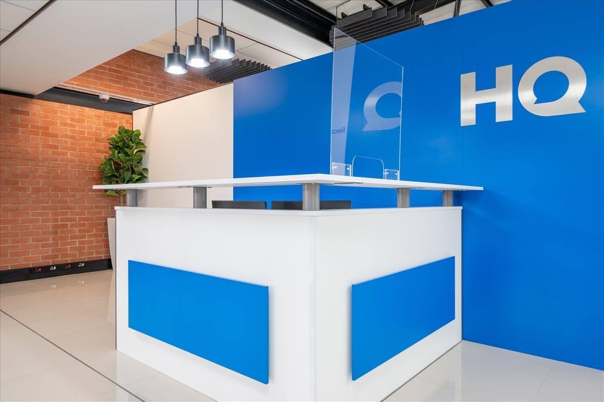 Modern reception desk at Tower B, Northlands Corner with blue branded feature wall.