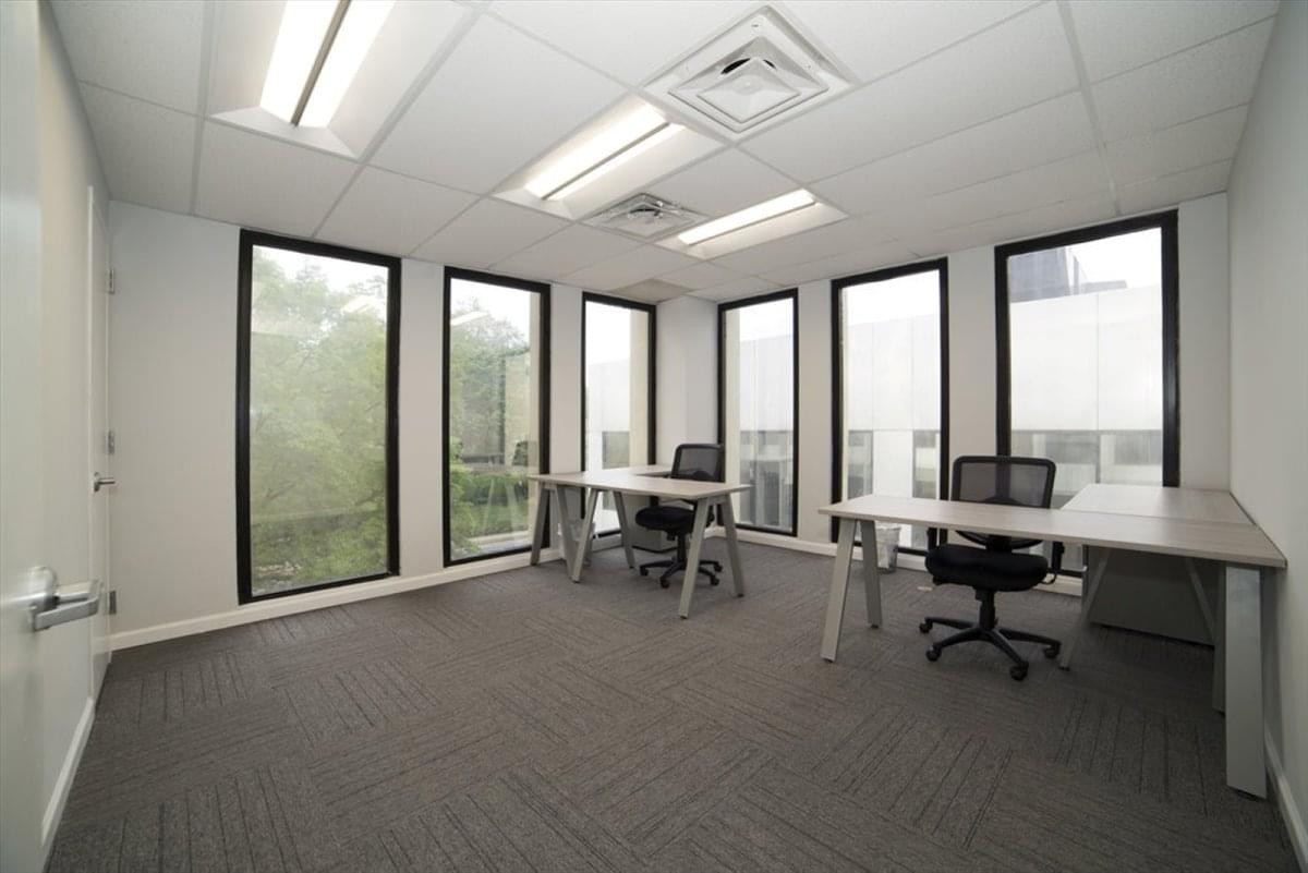 Bright, spacious office at Cape Town City Centre with multiple desks and floor-to-ceiling windows.