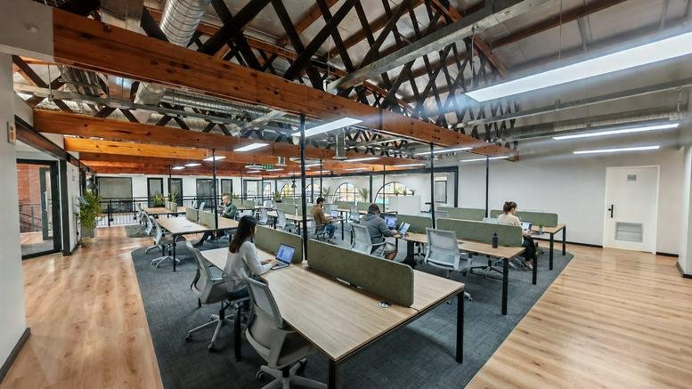 Spacious open-plan workspace at Sauvignon Street, Nooitgedacht Village with exposed timber trusses and natural light.