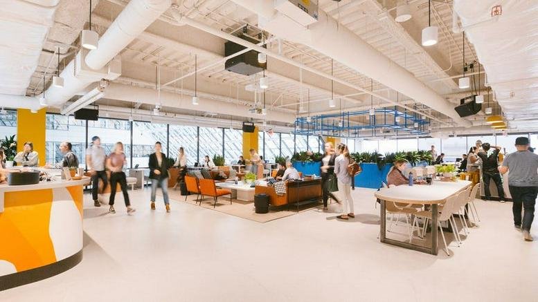 Wide interior view of the vibrant common area and collaborative workspace at 155 West Street, Sandton.