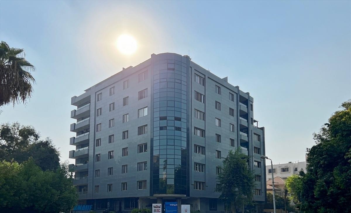 Exterior view of the modern glass and stone facade at Building No. 55.