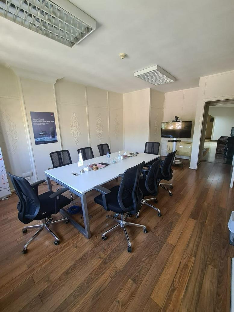 Meeting room at 19 Helmy El-Masry Street, Heliopolis with white table and ergonomic chairs.