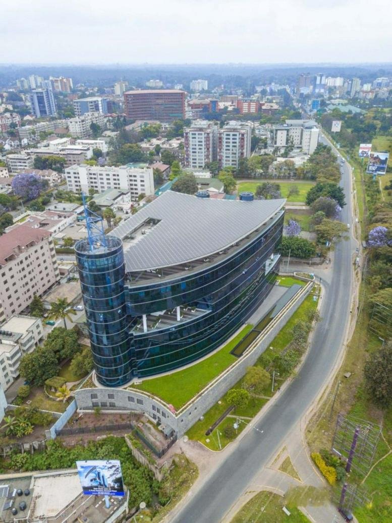 High-angle exterior view of the modern, glass-facade 1 Park Avenue Building.