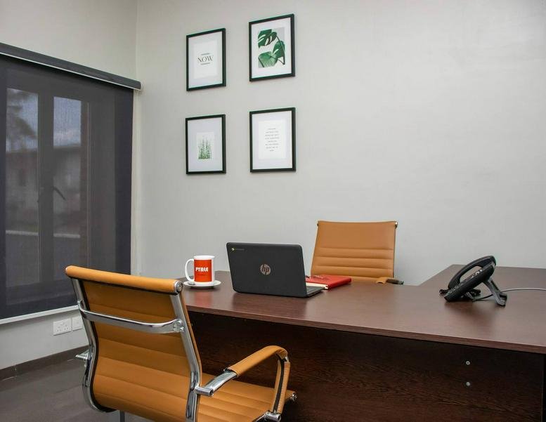 Bright private office at 21 Bekwere Wosu Street featuring a modern desk and ergonomic seating.