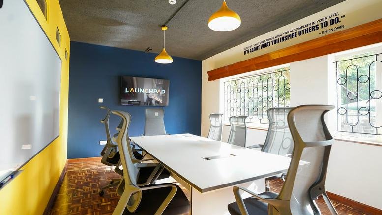 Professional meeting room at 29 Westlands Avenue featuring a blue accent wall and large whiteboard.
