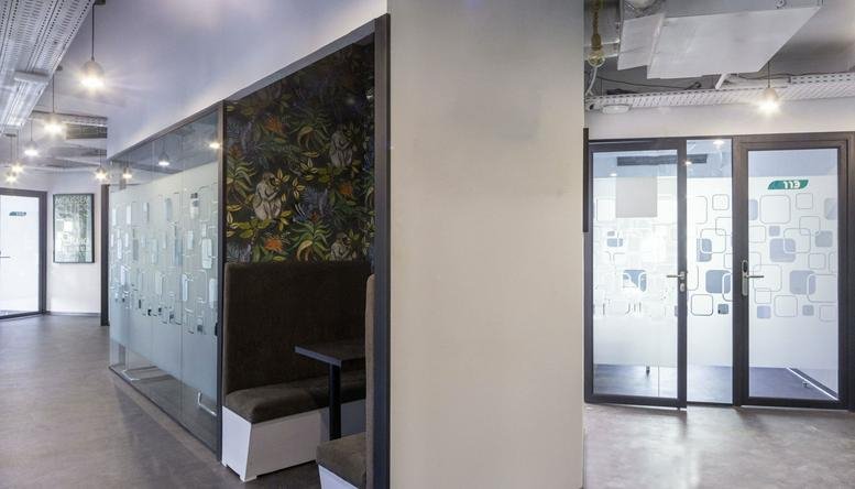 Lounge area at 3 Al Massira Al Khadra Boulevard featuring a nature-themed feature wall and booth seating.