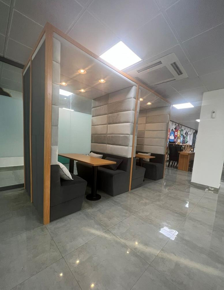 Modern privacy pods with cushioned seating and wood tables at 42 Saka Tinubu Street, Victoria Island.