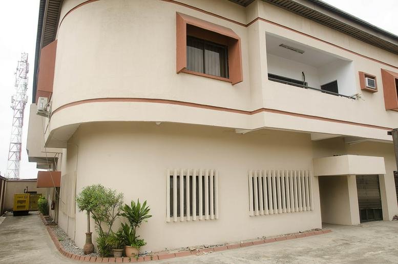 Exterior view of the light-colored multi-story building at 70b Olorunlogbon Street, Anthony Village.