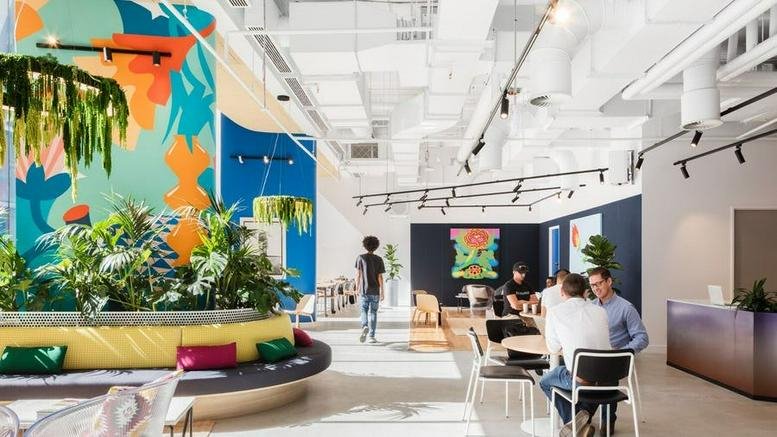 Spacious reception and lounge at 80 Strand Street, Cape Town featuring vibrant mural art and indoor greenery.